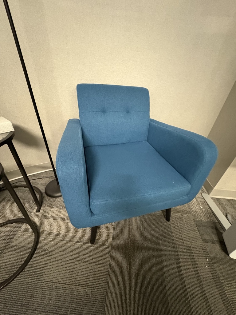 Blue fabric tufted arm chair with black feet 