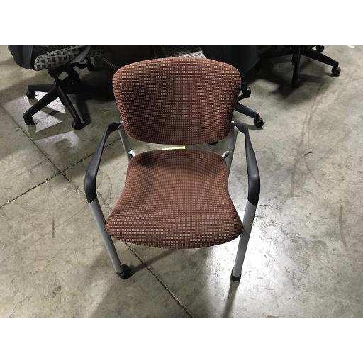 Orange and black patterned chair (w/ arms and wheels)